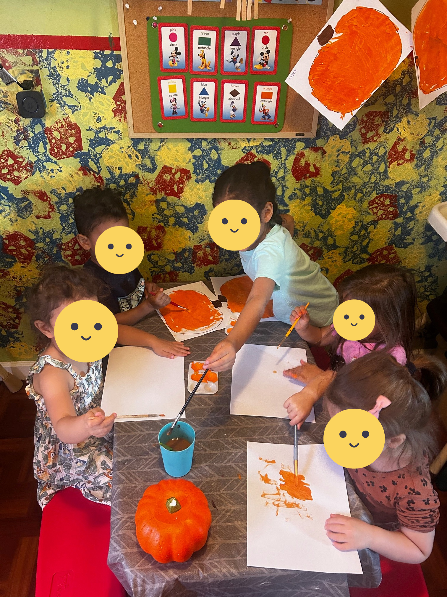 Children painting pumpkins.